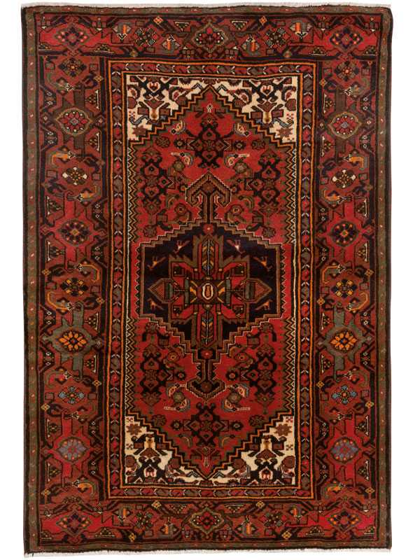 Tappeto persiano khamse rosso, con medaglione centrale stilizzato a forma di fiore e motivi decorativi floreali stilizzati su tutto il campo e lo spesso brodo del tappeto