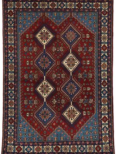 Tappeto persiano originale yalameh con motivi decorativi geometrici a rombo uncinati su campo rosso e motivi floreali stilizzati, e spesso bordo decorato a rombi