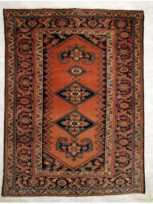 Tappeto Ferahan antico con doppio medaglione centrale su fondo arancio e dettagli decorativi floreali sullo spesso bordo