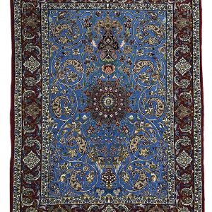 tappeto persiano originale isfahan azzurro con medaglione centrale e spesso bordo rosso, decorato con motivi floreali e di piante