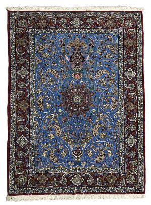 tappeto persiano originale isfahan azzurro con medaglione centrale e spesso bordo rosso, decorato con motivi floreali e di piante